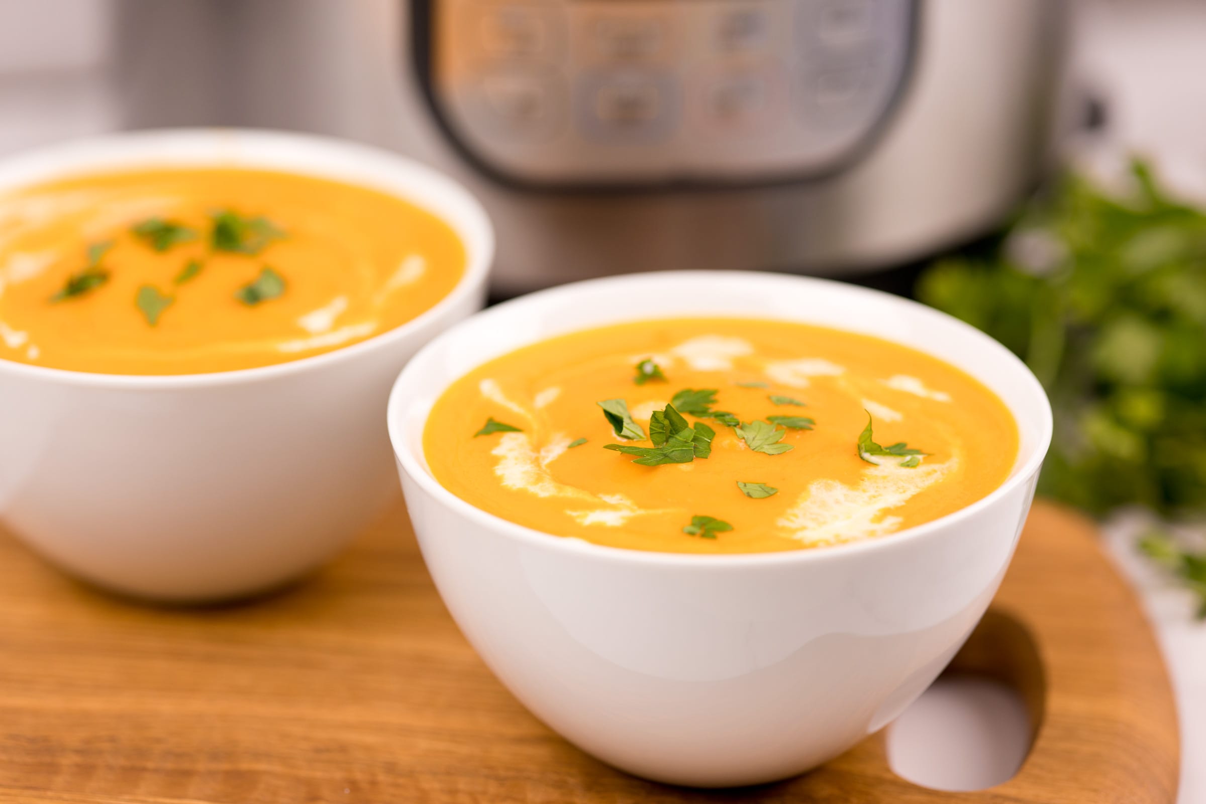 Crème de carottes fait au Instant Pot servie dans deux bols blancs