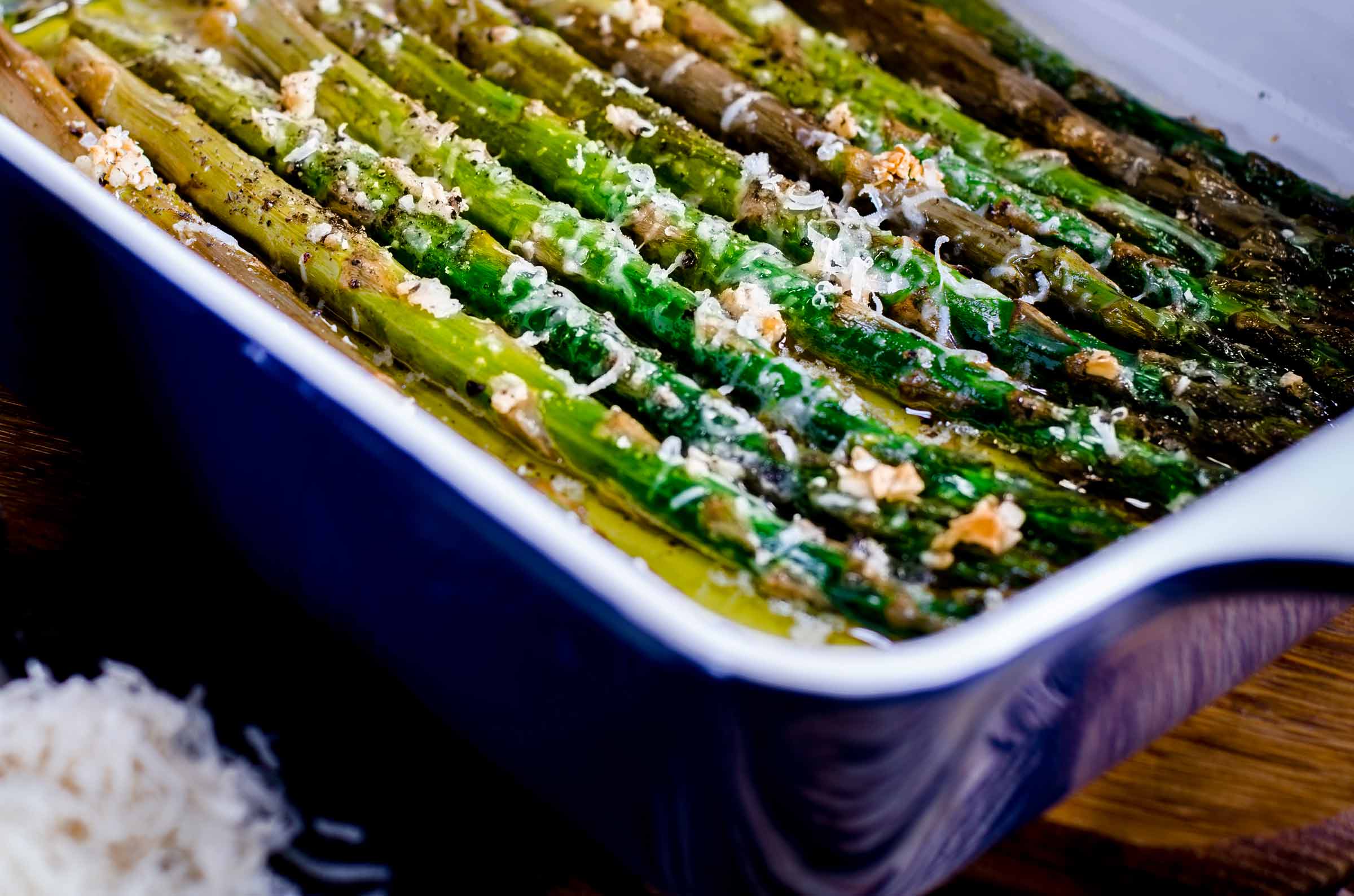 Asperges rôties au parmesan dans un plat de cuisson bleu